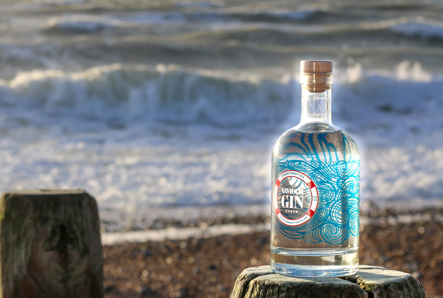 Bottle of Saviour gin on Eastbourne beach