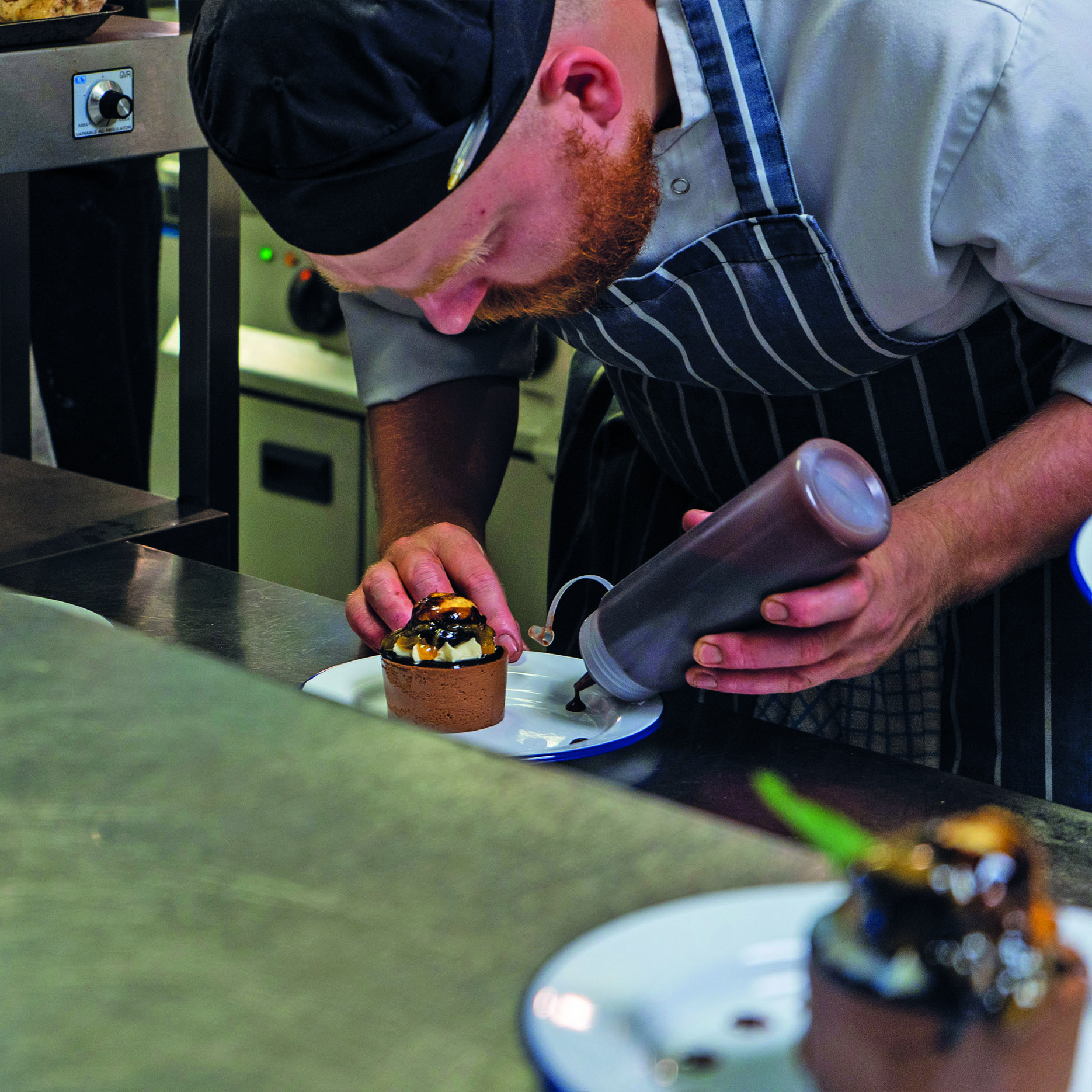 Chef plating up dessert from 3 Course private hire menu