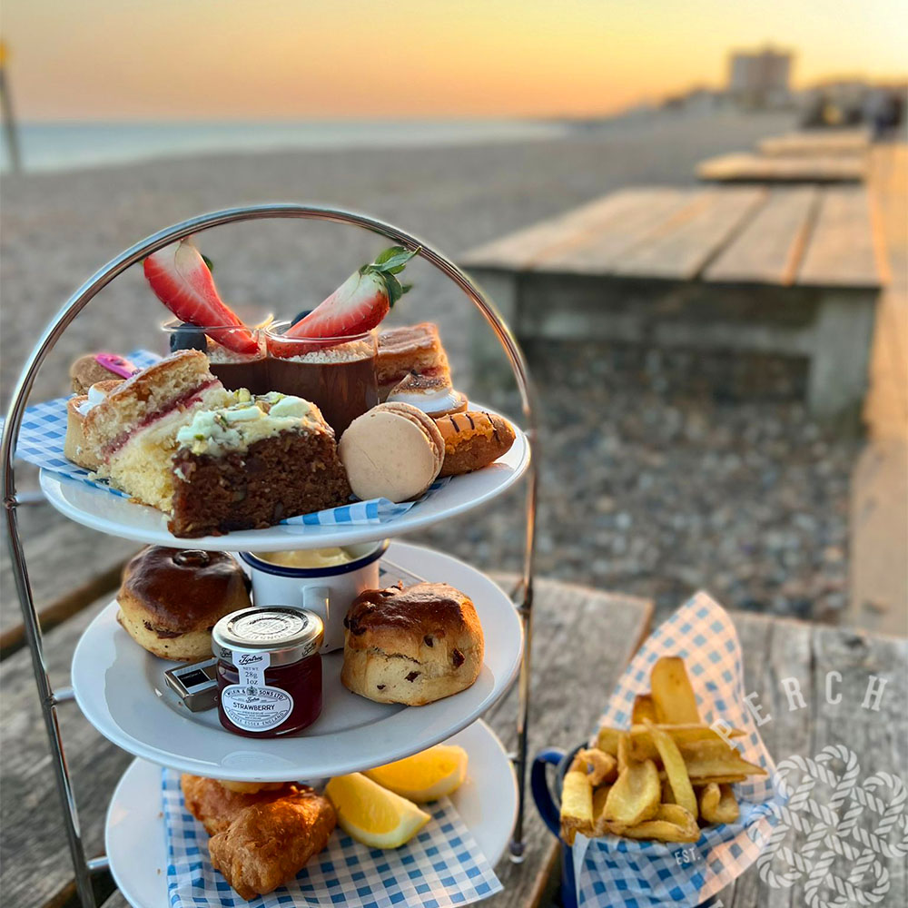 Mother's Day Afternoon Tea on the beach. Mini fish & chips, scones with clotted cream and jam finished with a selection of sweet treats